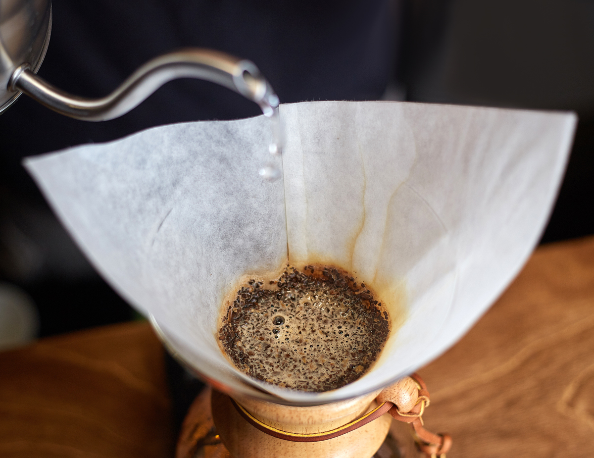 Pour over coffee as water is dripping onto coffee grounds in filter