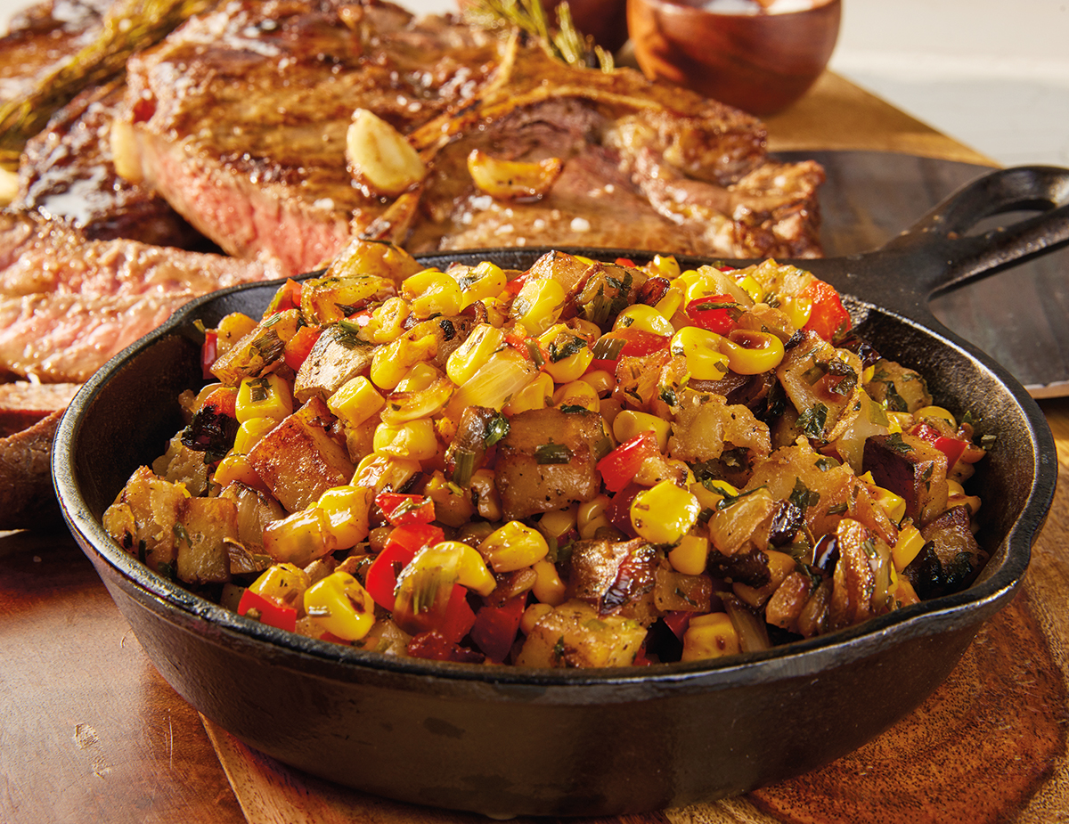 Cowboy Steak with Sweet Corn Hash in a cast iron skillet